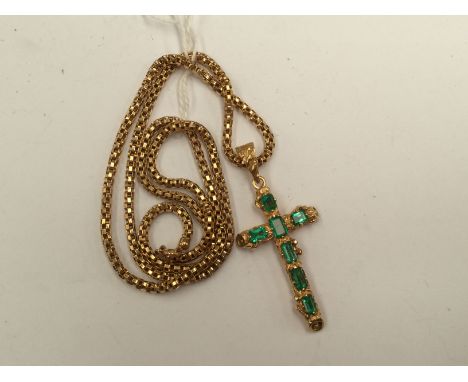 An 18k yellow gold textured crucifix pendant set seven various square cut emeralds; together with a yellow metal snake link c