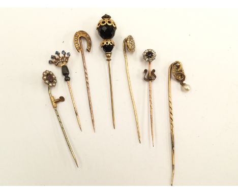 An Edwardian gold stick pin in the form of a coronet set five sapphires and seed pearls, a stick pin with pendant baroque pea