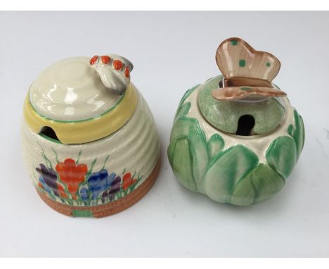 A Clarice Cliff Crocus pattern honey pot; together with a jam pot with Butterfly finial (2) 