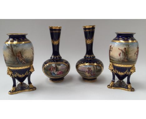 A pair of Vienna 'Gracien' tripod vases, the bodies painted with classical figures in a landscape setting with a mountainous 