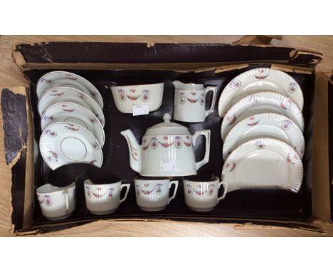 A child's boxed tea service, dating from approx early 1900s, ribbed design, with floral swags and bows pattern 