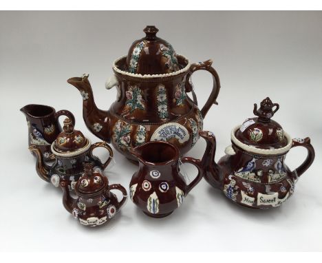 A 19th Century Bargeware teapot and cover; three smaller graduated modern teapots 'Home Sweet Home'; two jugs (6) 