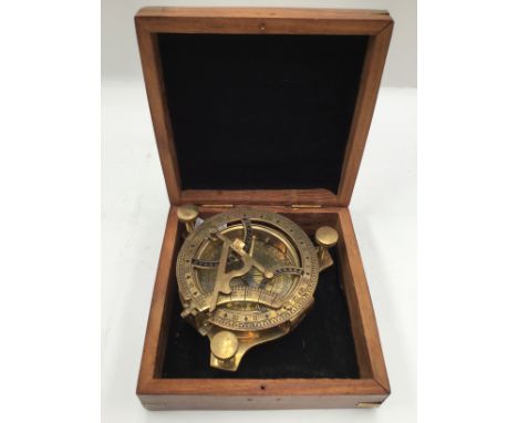 A cased reproduction brass ships compass, incorporating sundial, miniature navigation set, sextant by West of London 