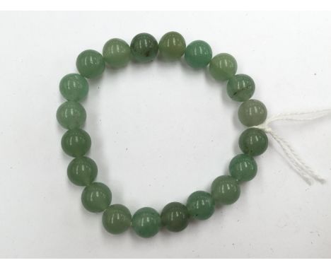 A Jade bracelet of green beads 