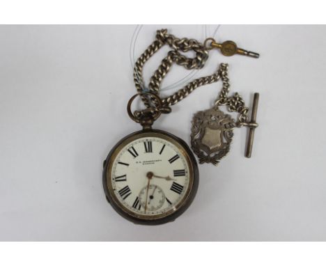 A silver open faced pocket watch on a silver chain 