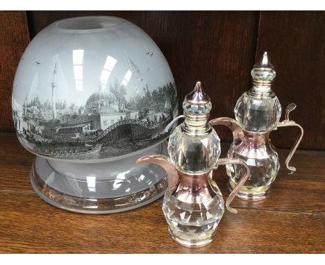 A glass candle lamp and a pair of Middle Eastern crystal jugs (3)