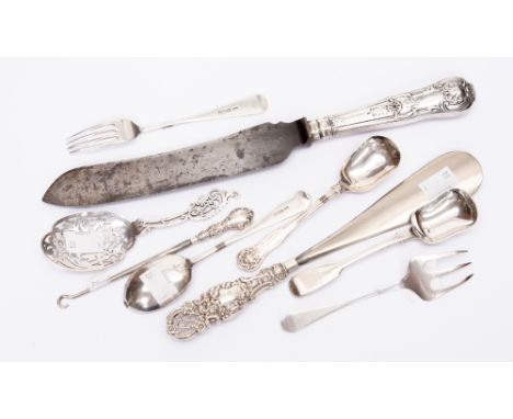 A collection of six various items of silver flatware, including two cheese scoops, a meat fork, a reticulated serving spoon a