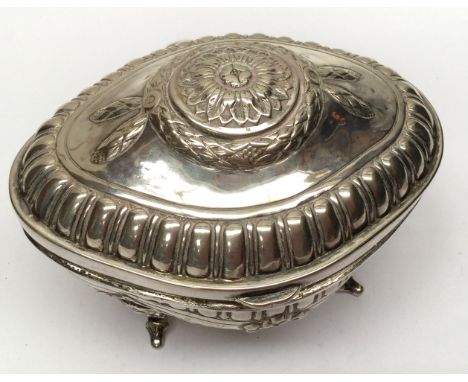 A late Victorian continental German sugar caddy, footed ogee bombe form, embossed garland and ribbon below egg and dart borde