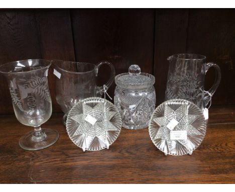 Two water jugs, one biscuit barrel and cover, celery vase and two pressed glass dishes (6)