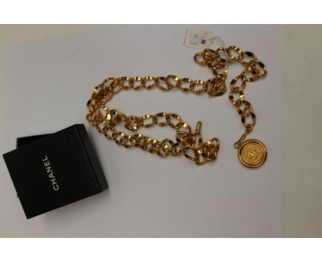 CHANEL gold tone chain belt, with suspended monogram embossed medallion charm, signed Chanel, length approx 81cm