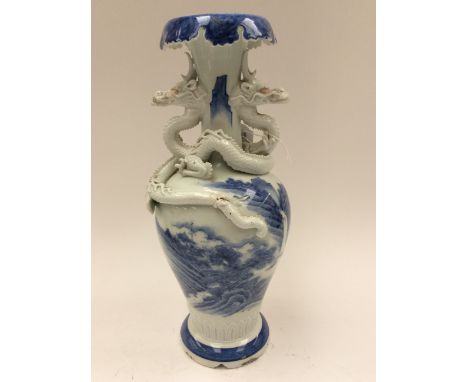 A Chinese early 19th Century baluster vase, blue and white mountain and sea scene, with two blanc du chine applied Dragons (s