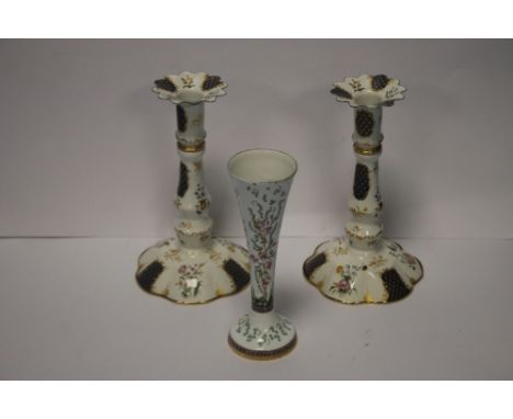 A PAIR OF ENGLISH ENAMEL ON COPPER HAND PAINTED CANDLESTICKS WITH GILT MOUNTS TOGETHER WITH ANOTHER HALCYON DAYS BUD VASE