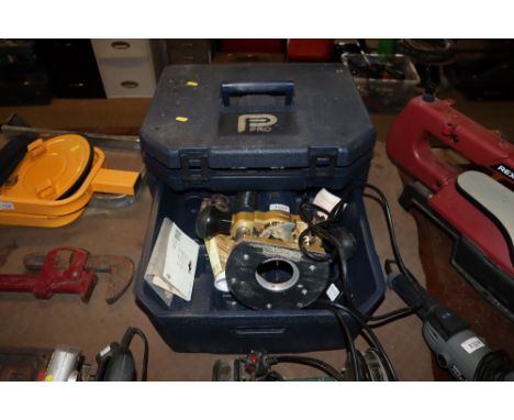 A Performance Power Tools 230v router in fitted plastic case with instruction guide and various router attachments