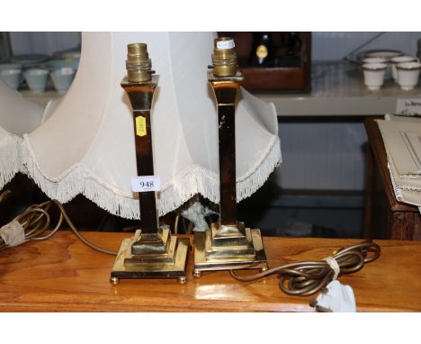 A pair of brass candlestick style table lamps
