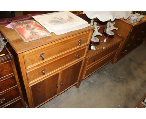 A light oak two drawer chest and an oak linen cabinet