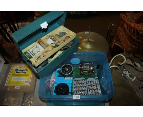 A plastic box containing a plastic fishing tool box with a quantity of lures, two Shakespeare fishing reels and one other etc