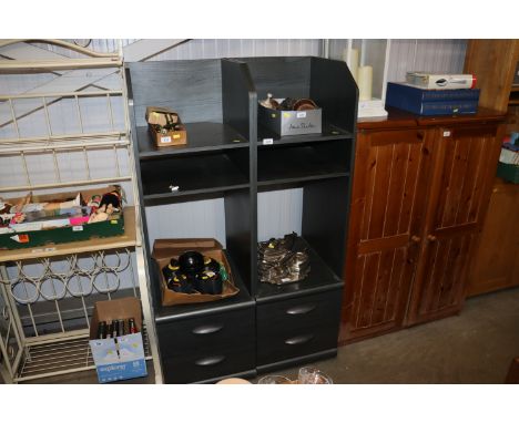 A pair of modern shelf units each fitted two drawers below