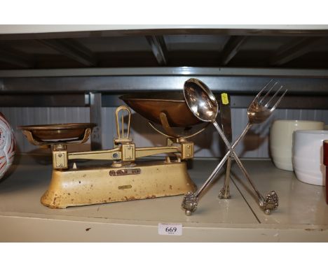A recipe book holder formed from cutlery and a set of scales