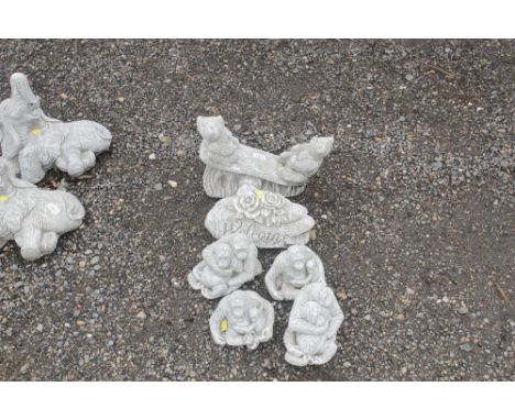 Six concrete garden ornaments in the form of a welcome sign, teddy bears on a sea saw and gorillas