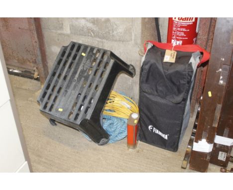 A pair of Fiamma motorhome ramps in carry case, a length of blue rope, a 110v extension lead, 4L of four stroke motor oil (10