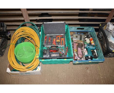 Three crates containing various tools and hose pipe etc