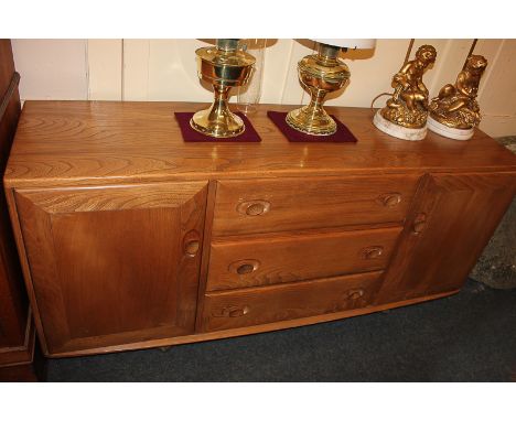 An Ercol light elm sideboard with two cupboards and three central drawers and cutlery tray, circa 1965, 156cm