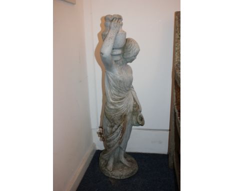 A garden stone composition ornament of a classical woman holding a jug and pitcher, 88cm high