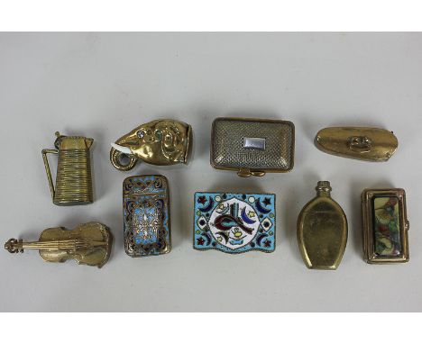 A collection of nine brass vesta cases, six in novelty shapes, violin, bottle, elephant's head, pitcher, handbag, and violin 
