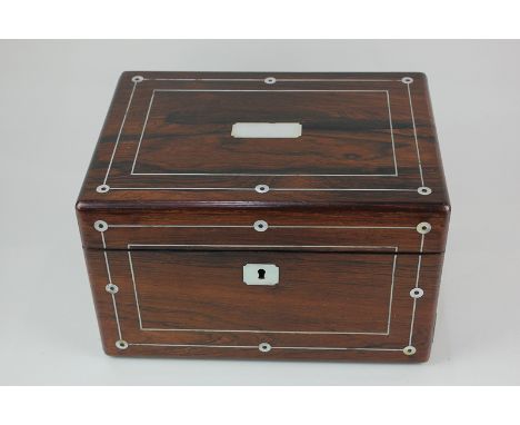 A Victorian rosewood dressing table box inlaid with mother of pearl, with fitted interior containing four bottles / jars, and