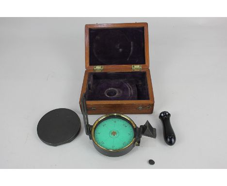 A hand held sighting compass,  with removable handle, in fitted wooden box, diameter 7.5cm