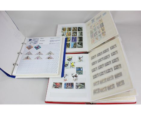 A pair of stamp albums containing 20th century world stamps, and a Stanley Gibbons Trident stamp album