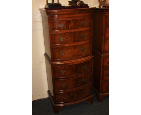 A reproduction bowfront walnut tallboy, with three over three drawers, on bracket feet