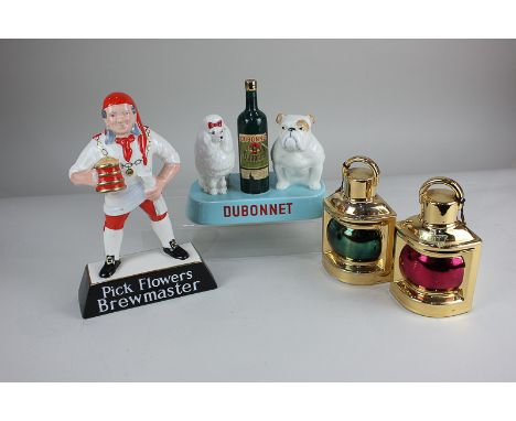 A Beswick pottery Dubonnet advertising figure group modelled as a poodle and a bulldog flanking a bottle, with paper label, 1