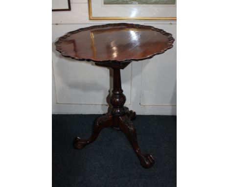 A George III style circular side table with pie-crust border, on bird cage support and foliate carved tripod base, 60cm