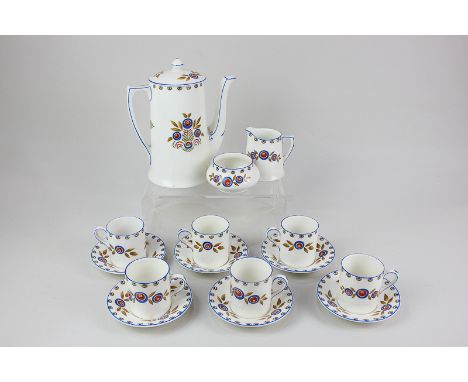 A Crown Ducal ware coffee set for six, decorated with stylized blue and red floral sprays on cream ground, comprising coffee 