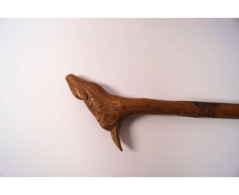 A wooden walking stick with carved shaft and the knop as a deer 