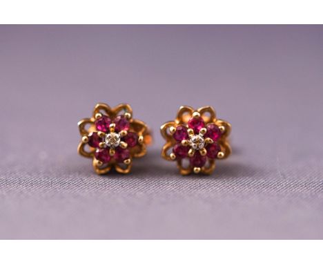 A pair of 9ct gold, ruby and diamond cluster stud earrings. Weight: 1.8 grams