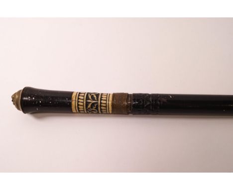A 19th century Anglo-Indian swordstick with carved bone and ebonised wood handle and brass lion's mask mount