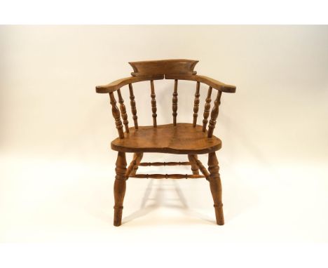 Smokers bow chair with turned spindle back, shaped solid seat and turned legs