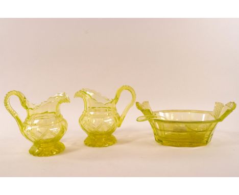 A pair of Victorian uranium cut glass jugs with flared foot, 13cm high, together with a bowl and ladle