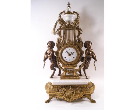 A contemporary Italian marble and gilt metal mantel clock of lyre form, flanked by satyrs, the eight day movement striking ha