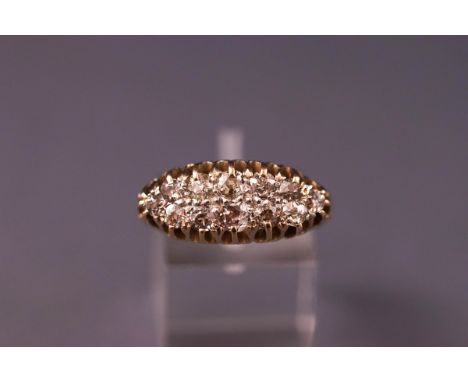 A yellow metal cluster ring set with twelve old cut diamonds 2.30mm to 3.00mm. Colour: K/L Clarity: SI1 to I1. Stamped 18ct. 