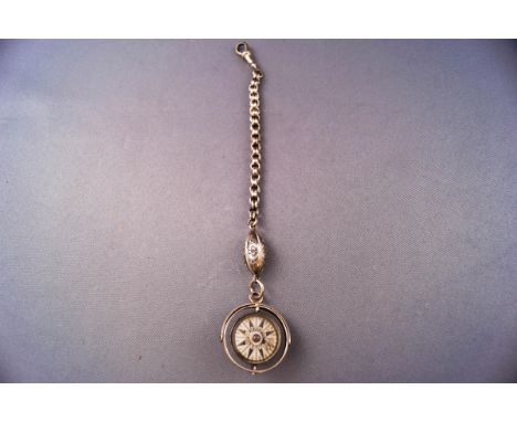 An early 20th century Continental gimbal mounted compass pendant, hung from a short length of twin-belcher chain, the compass