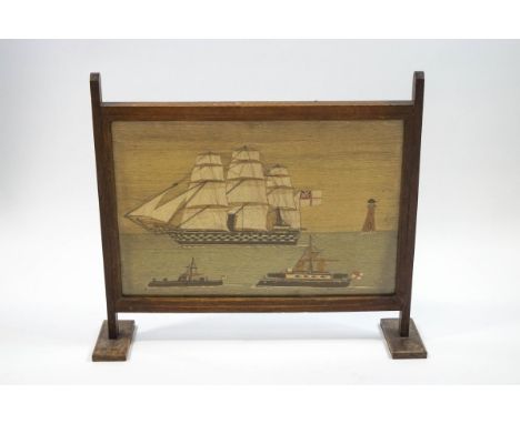 A 19th century ship's woolwork picture of a three masted Man O'War, a lighthouse and two further boats inset into a later oak