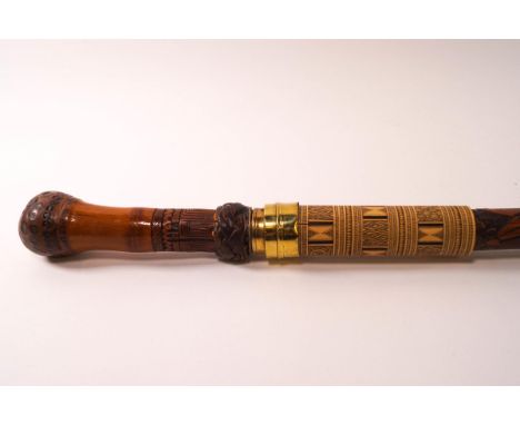 A Japanese bamboo sword stick, the sheath carved with warriors