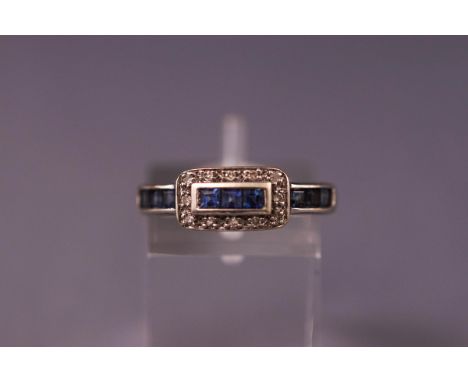 A white metal sapphire and diamond dress ring. Stamped DIA. Hallmark has worn. Tests indicate 18ct gold. Size: K Weight: 2.9 