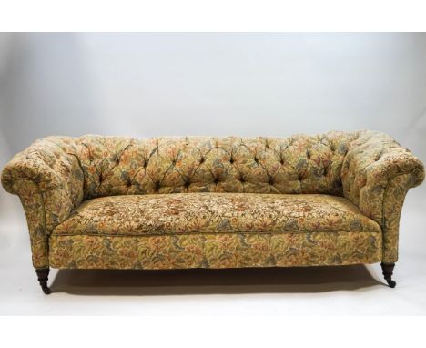 A Victorian Chesterfield sofa with button back, on turned legs with ceramic casters, 200cm wide