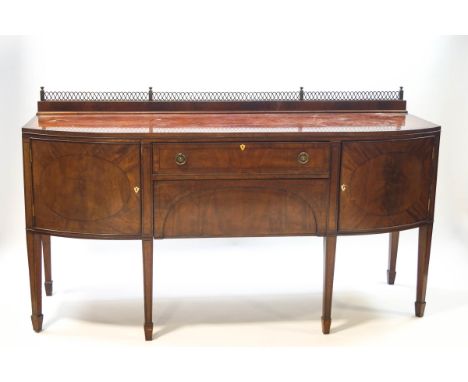 A 19th century mahogany bow front sideboard, crossbanded with ebony stringing, two central drawers flanked by cupboards, 104c