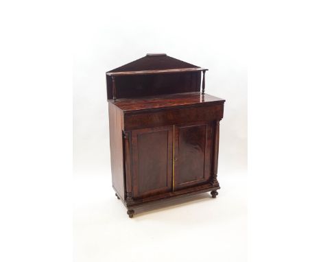 A Victorian mahogany chiffonier with raised shelf back, above two panelled doors flanked by turned columns on ball feet, 127c