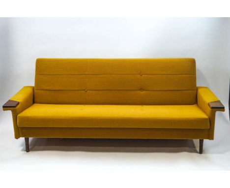 A mid-20th century three seat sofa with buttoned mustard yellow upholstery, 208cm wide (sold as a collector's item only)